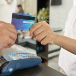 Close-up image of customer paying with card in beauty salon